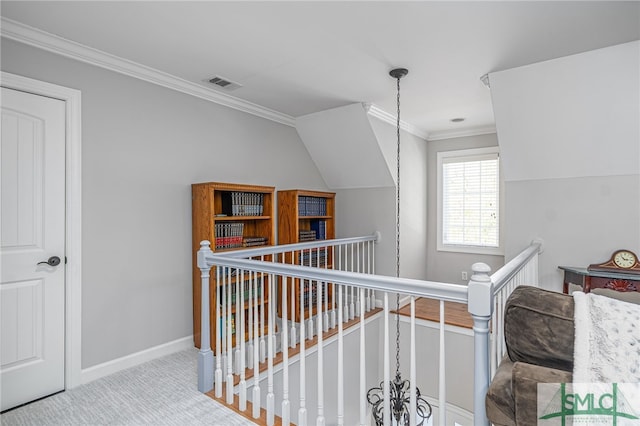 hallway with visible vents, an upstairs landing, carpet, crown molding, and baseboards