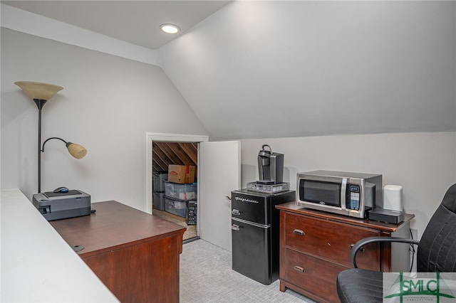 office space featuring light carpet and lofted ceiling