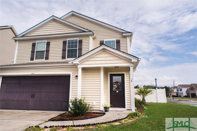 view of front of property featuring concrete driveway and a garage