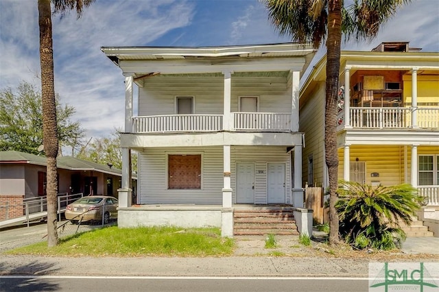 view of front facade with a balcony and covered porch