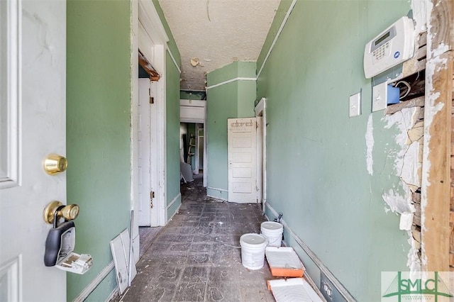 hallway with a textured ceiling