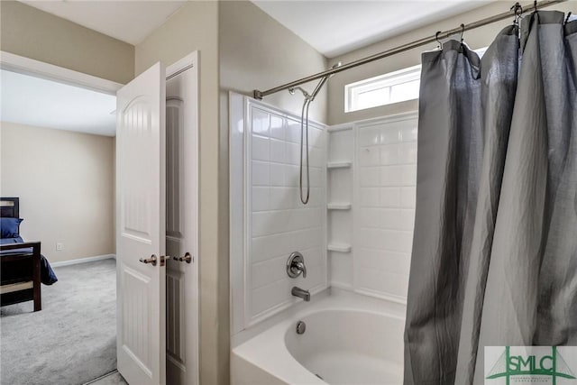 bathroom with shower / bath combo with shower curtain and baseboards