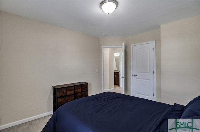 bedroom with baseboards and carpet floors