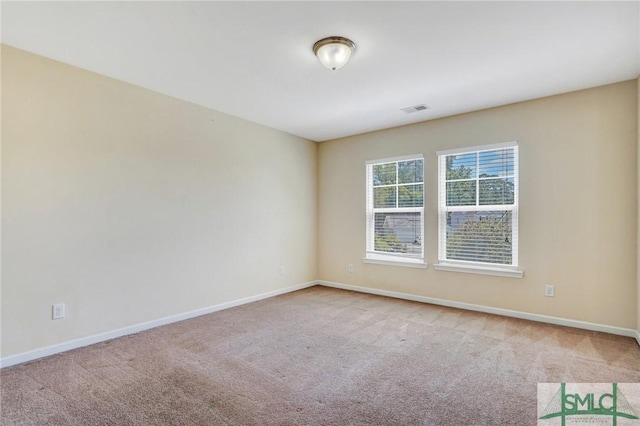 unfurnished room with visible vents, carpet flooring, and baseboards