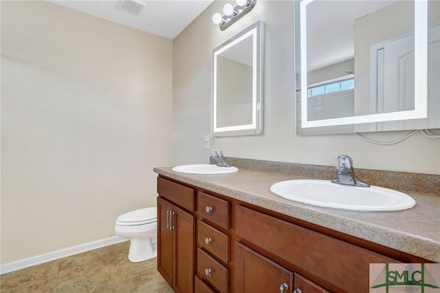 full bathroom featuring double vanity, toilet, visible vents, and a sink