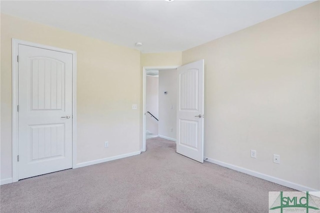 unfurnished bedroom with baseboards and carpet flooring