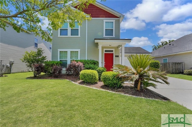 view of front of property featuring fence and a front lawn