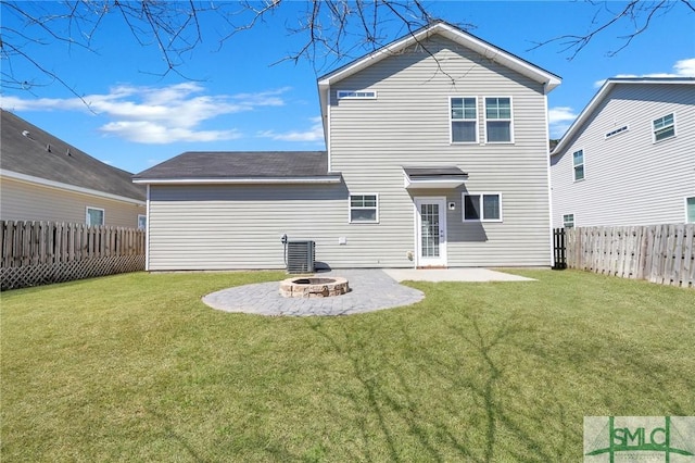 back of property featuring central air condition unit, a fenced backyard, a yard, a patio, and a fire pit