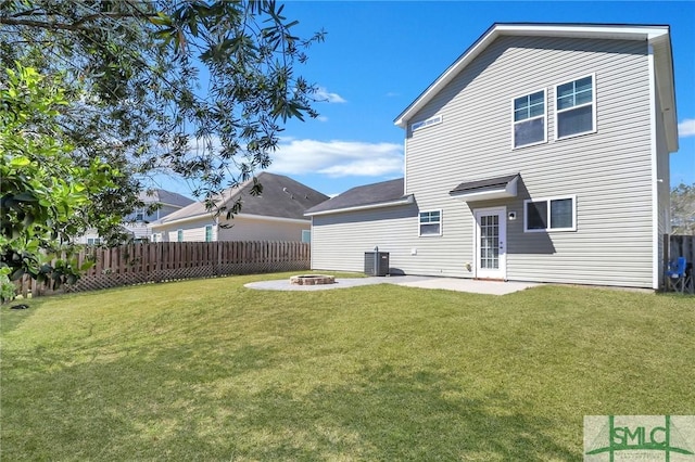 back of house with fence, a patio area, an outdoor fire pit, central air condition unit, and a yard