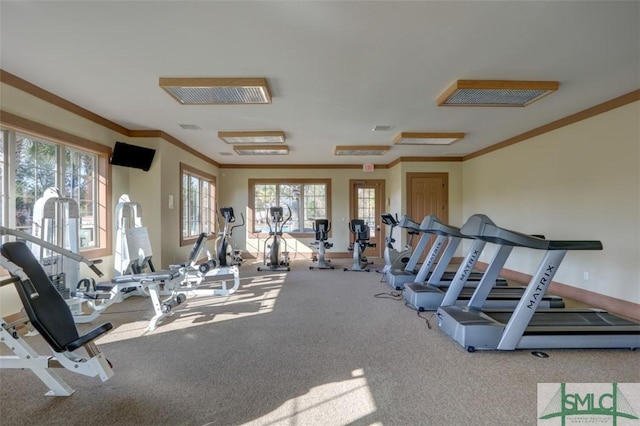 gym with visible vents, baseboards, carpet, and ornamental molding