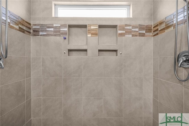 bathroom with a tile shower