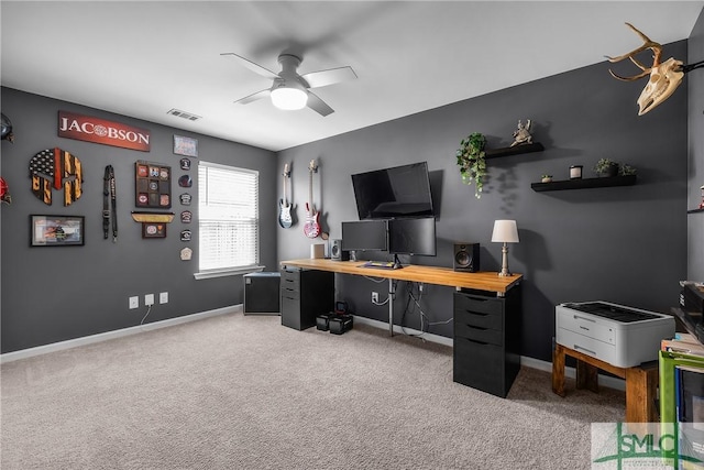 office featuring light carpet, visible vents, baseboards, and a ceiling fan