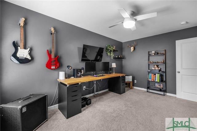 office area with baseboards, a ceiling fan, and carpet