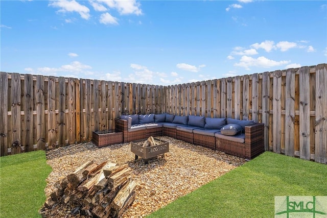 view of yard featuring an outdoor living space with a fire pit and a fenced backyard