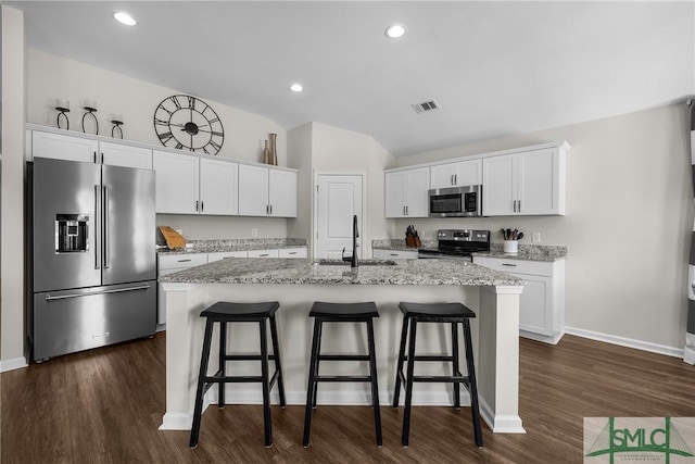 kitchen featuring a sink, dark wood-type flooring, visible vents, and stainless steel appliances