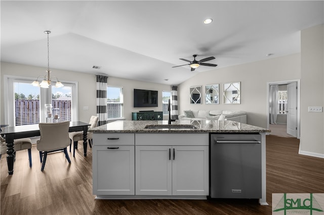 kitchen featuring light stone counters, dark wood-style flooring, hanging light fixtures, vaulted ceiling, and open floor plan