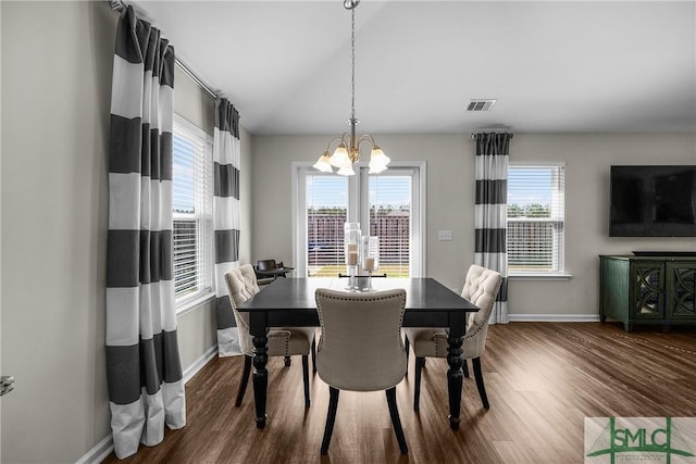 dining space with a notable chandelier, visible vents, dark wood finished floors, and a wealth of natural light