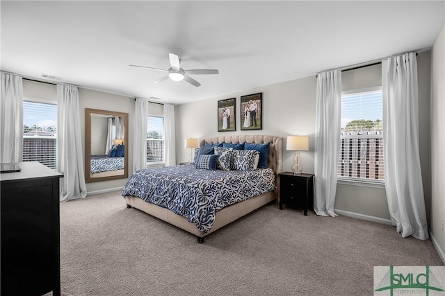 bedroom with multiple windows, carpet flooring, a ceiling fan, and visible vents