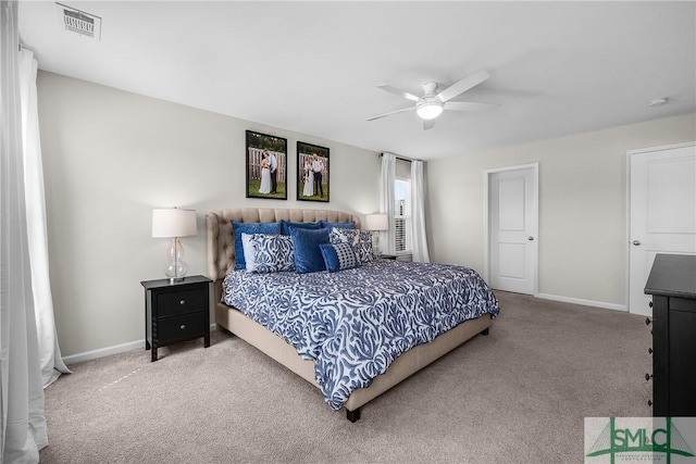 carpeted bedroom with baseboards, visible vents, and ceiling fan