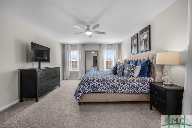 bedroom with light colored carpet, baseboards, and ceiling fan