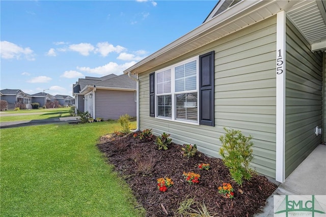 view of property exterior with a residential view and a yard