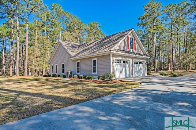 view of home's exterior with concrete driveway and a yard