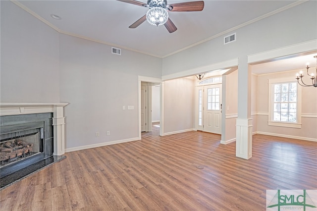 unfurnished living room with visible vents, wood finished floors, and a fireplace with raised hearth