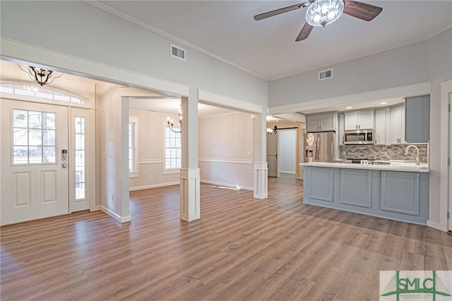 interior space featuring wood finished floors, visible vents, and ornamental molding