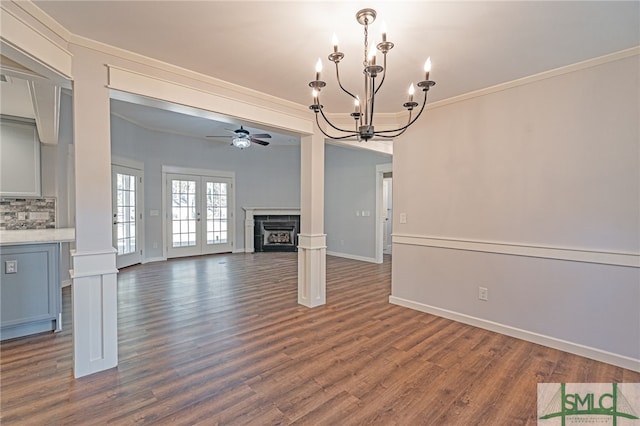 unfurnished living room featuring crown molding, a fireplace, dark wood-style flooring, and baseboards