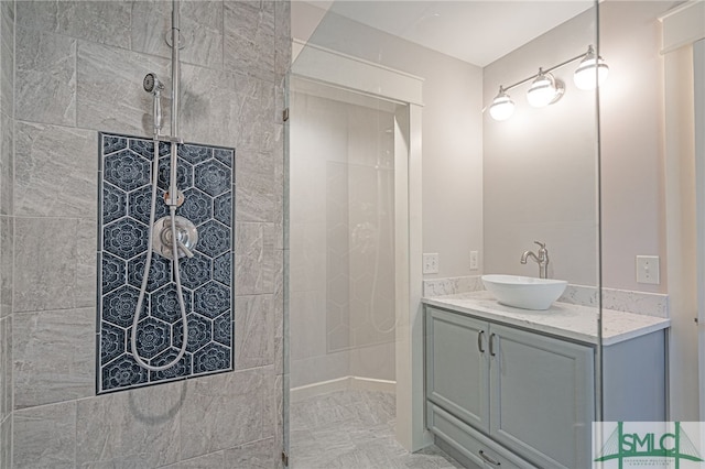 bathroom with vanity and a tile shower