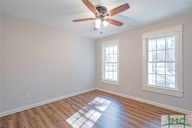 unfurnished room featuring a ceiling fan, baseboards, and wood finished floors