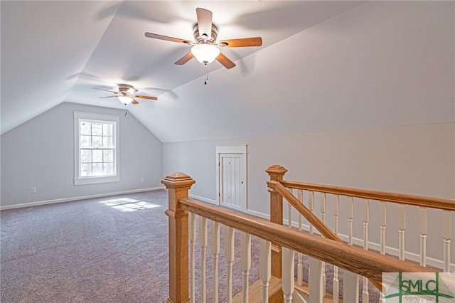 additional living space featuring baseboards, lofted ceiling, carpet, and a ceiling fan