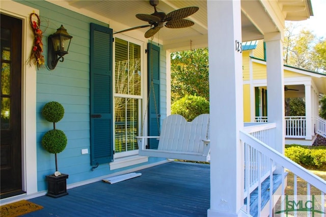 wooden terrace featuring a porch and a ceiling fan