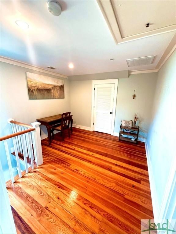 hallway with baseboards, light wood-type flooring, and ornamental molding