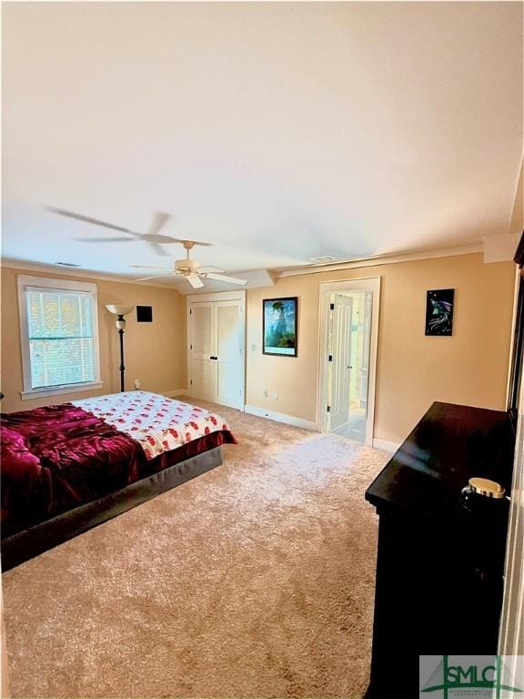 bedroom with baseboards, crown molding, and carpet