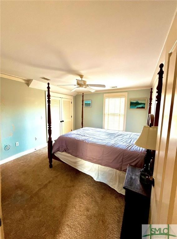 carpeted bedroom featuring visible vents, a ceiling fan, and baseboards