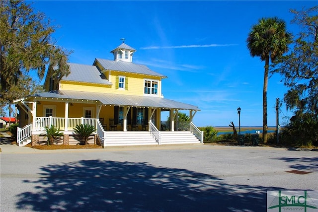 view of front of house featuring metal roof and covered porch