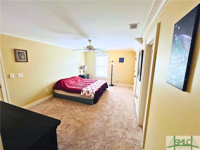 bedroom featuring light colored carpet, visible vents, crown molding, and baseboards