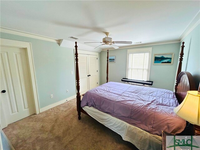 carpeted bedroom featuring baseboards, ceiling fan, visible vents, and crown molding