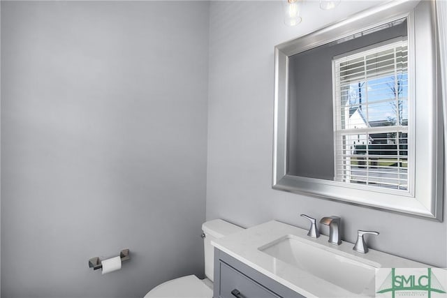 bathroom featuring toilet and vanity