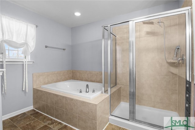 bathroom featuring a bath, recessed lighting, a shower stall, and baseboards