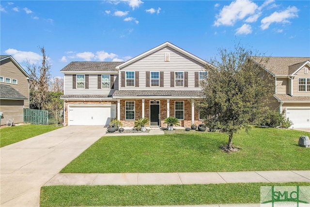 traditional home featuring brick siding, a garage, driveway, and a front yard