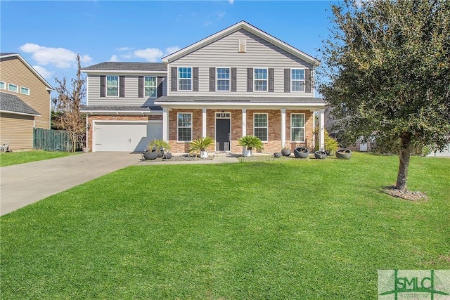 view of front of property with brick siding, an attached garage, fence, a front yard, and driveway