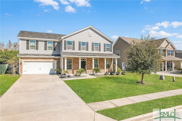 traditional-style home with brick siding, driveway, an attached garage, and a front yard