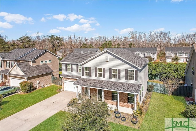 traditional-style home with a residential view, driveway, a front lawn, and fence