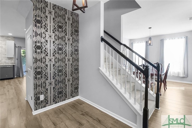 stairs with recessed lighting, baseboards, and wood finished floors