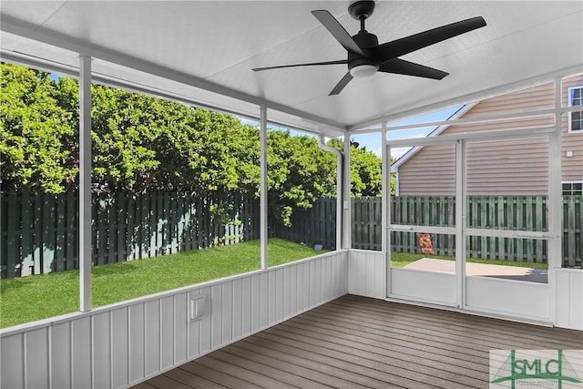 unfurnished sunroom featuring ceiling fan