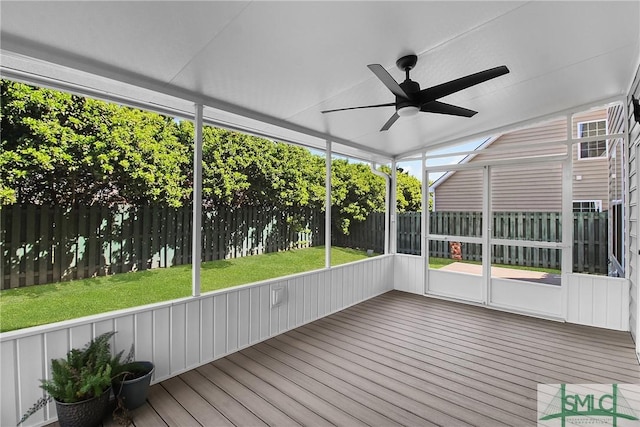 unfurnished sunroom featuring a ceiling fan