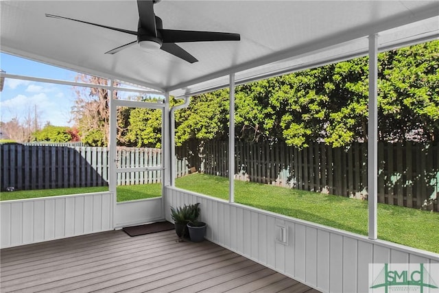 unfurnished sunroom with ceiling fan