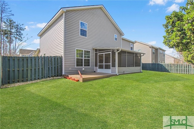 back of property featuring a yard, a fenced backyard, a sunroom, and a wooden deck